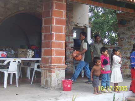 Unloading food at campiemento, kids are very interested in what is going on